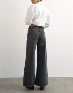 Model wearing Horizon mid rise wide leg jean in washed black