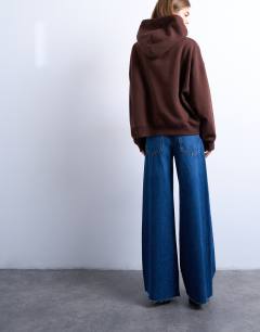 Model wearing Horizon mid rise wide leg jean with raw hem in rich blue