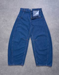 Model wearing Horseshoe high rise barrel jean circular design in indigo rinse