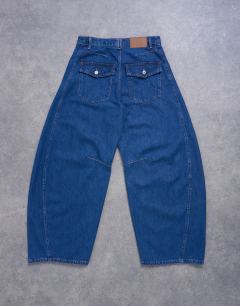 Model wearing Horseshoe high rise barrel jean circular design in indigo rinse