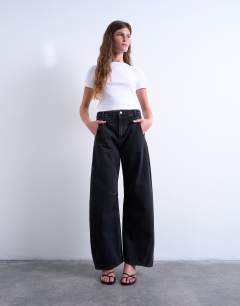Model wearing Horseshoe high rise barrel jean circular design in washed black