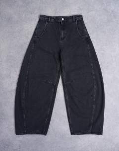 Model wearing Horseshoe high rise barrel jean circular design in washed black