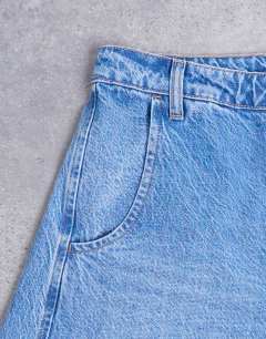 Model wearing Horseshoe high rise barrel jean in mid blue