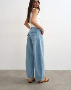 Model wearing Horseshoe mid rise barrel jean in bleach stripe