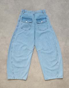 Model wearing Horseshoe mid rise barrel jean in bleach stripe