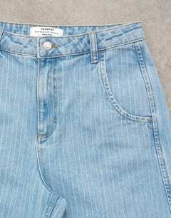Model wearing Horseshoe mid rise barrel jean in bleach stripe
