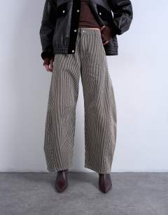 Model wearing Horseshoe mid rise barrel jean in brown stripe