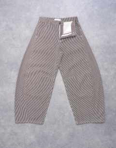 Model wearing Horseshoe mid rise barrel jean in brown stripe