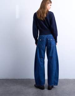 Model wearing Horseshoe mid rise barrel jean in indigo rinse