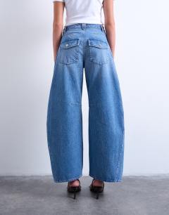 Model wearing Horseshoe mid rise barrel jean in vintage blue