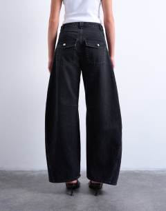 Model wearing Horseshoe mid rise barrel jean in washed black