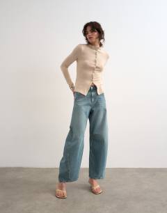 Model wearing Horseshoe mid rise barrel leg jean in green cast