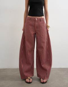 Model wearing Horseshoe mid rise jean in pink and red stripe
