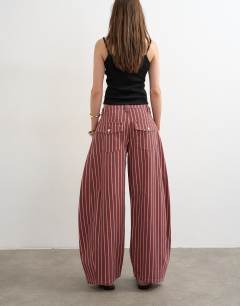Model wearing Horseshoe mid rise jean in pink and red stripe