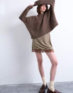 Model wearing Hot fix embellished mini skirt with lace trim in brown