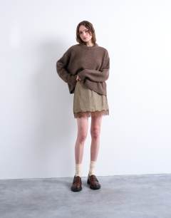 Model wearing Hot fix embellished mini skirt with lace trim in brown