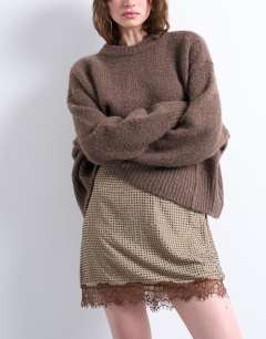 Model wearing Hot fix embellished mini skirt with lace trim in brown