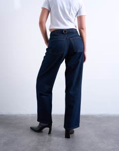 Model wearing Hourglass Cinch low rise relaxed jean in raw look indigo 