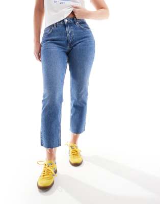 cropped mid rise straight jeans with raw hems in mid blue