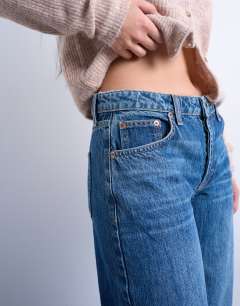 Model wearing Ember low rise straight leg jean in vintage blue