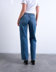 Model wearing Hourglass Ember low rise straight leg jean with knee rip in mid blue