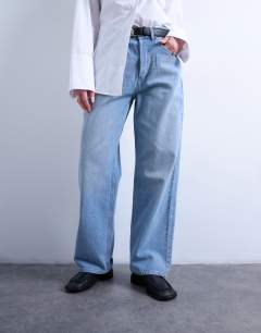 Model wearing Mid rise loose fit straight jean in bleach