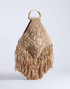 Model wearing Hugo weave tassel straw bag in natural