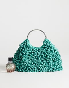 Model wearing Hunter medium bead grab bag with metal handle in teal