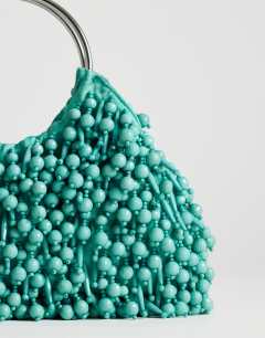 Model wearing Hunter medium bead grab bag with metal handle in teal