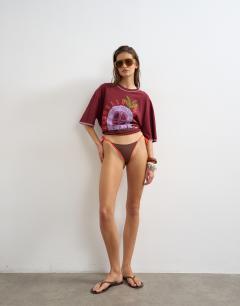 Model wearing Ibiza thong bikini bottom in chocolate and orange