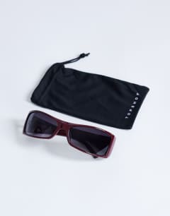Model wearing Ibiza wrapround rectangle sunglasses in burgundy