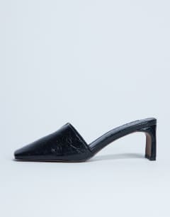 Model wearing Idea patent square toe mule in black