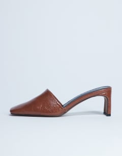 Model wearing Idea patent square toe mule in chocolate
