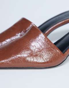 Model wearing Idea patent square toe mule in chocolate