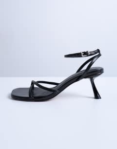 Model wearing Ila toe loop mid heel sandal in black