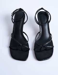 Model wearing Ila toe loop mid heel sandal in black