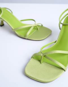 Model wearing Ila toe loop mid heel sandal in green