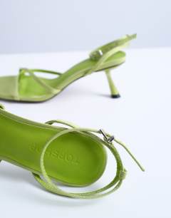 Model wearing Ila toe loop mid heel sandal in green