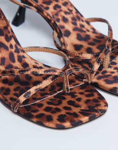 Model wearing Ila toe loop mid heel sandal in leopard print