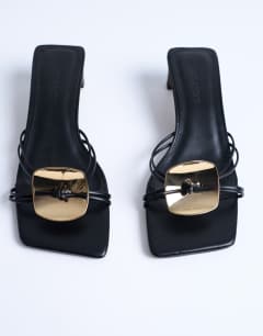 Model wearing Ilaria kitten heeled sandal with metal trim in black