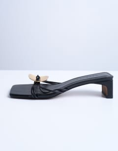 Model wearing Ilaria kitten heeled sandal with metal trim in black