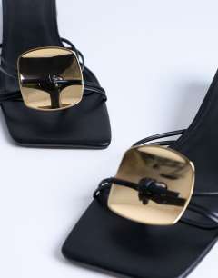 Model wearing Ilaria kitten heeled sandal with metal trim in black