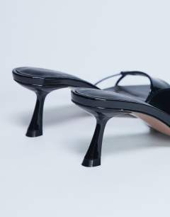 Model wearing Ily patent heeled mule in black
