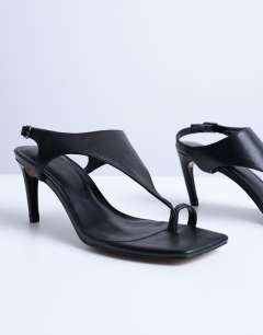 Model wearing Iman toe loop heeled sandal in black