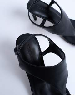 Model wearing Iman toe loop heeled sandal in black