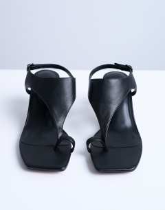 Model wearing Iman toe loop heeled sandal in black