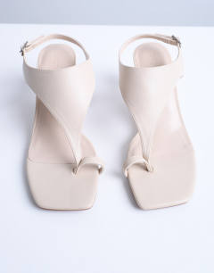 Model wearing Iman toe loop heeled sandal in off white