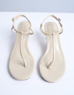 Model wearing Imani toe thong mid heel in off white