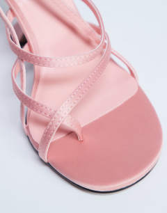 Model wearing Indigo strappy angled heel mule in peach