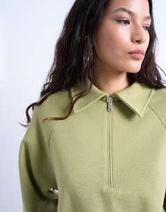 Model wearing Interlock bubble hem polo quarter zip sweat in green